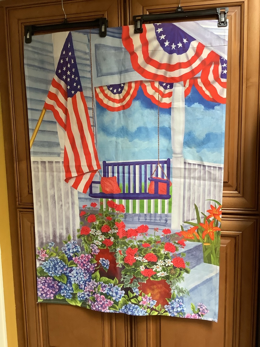 PATRIOTIC PORCH SWING WITH FLAGS AND A FLORAL SCENE